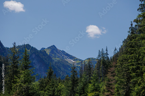 Very beautiful, majestic, mountains, with charming spruce forests that delight the eye against the blue sky.