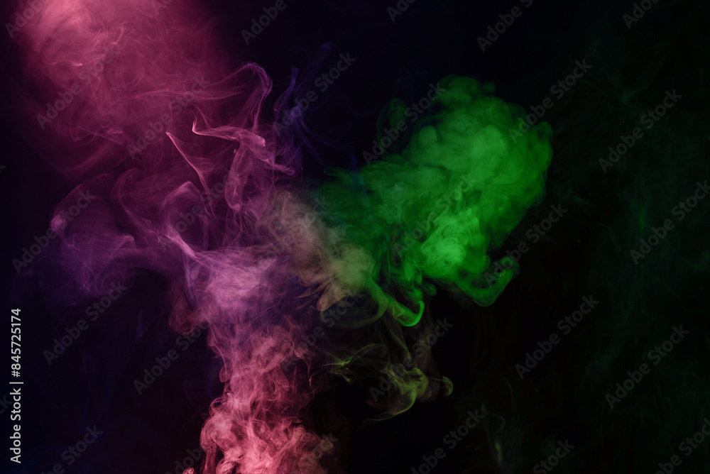 Fototapeta premium Green and pink steam on a black background.