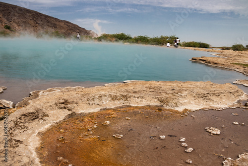 Alolabad geothermal area in Ethiopia with surreal landscape of colorful hot springs, steaming fumaroles, and erupting salt geysers in an arid, remote desert setting below sea level, Afar desert.  photo