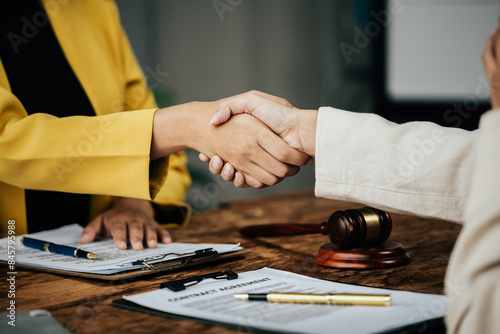 Obraz na plátně Close up of hands Lawyers explain and discuss matters of law then shakehands after and dealing contract agreement to clients discuss for prepare for the trial