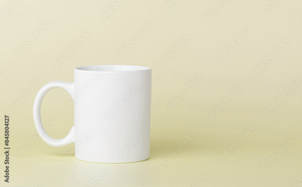 white cup for tea or coffee on a yellow background white cup for tea or coffee on a yellow background