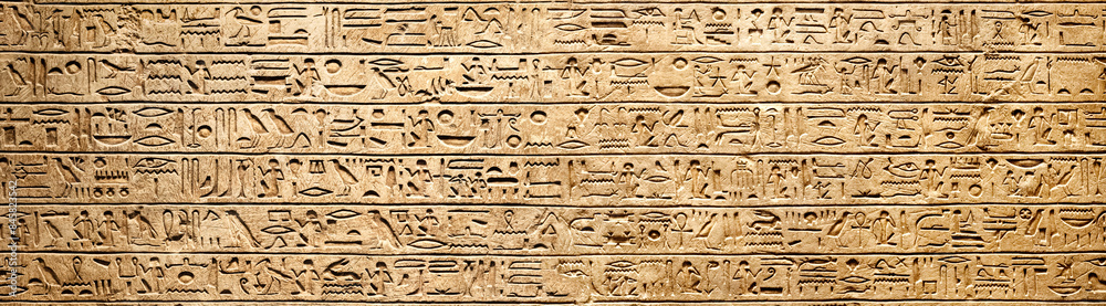 Old Egyptian hieroglyphs on an ancient background. Wide historical background. Ancient Egyptian hieroglyphs as a symbol of the history of the Earth. Old Egyptian hieroglyphs on an ancient background. Wide historical background. Ancient Egyptian hieroglyphs as a symbol of the history of the Earth.