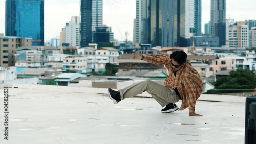 Professional hispanic break dancer practice B boy dance while multicultural friends at roof top. Young modern dancing group doing hip hop movement. Style,fashion,action. Outdoor sport 2024. Endeavor.