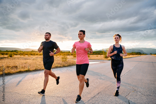 Athlete Leading Group Run at Sunset Amidst Stunning Nature © .shock