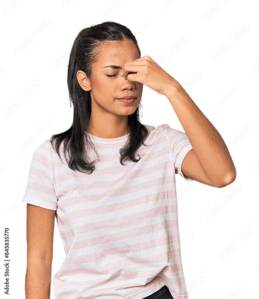 Young Filipina woman having a head ache, touching front of the face. Young Filipina woman having a head ache, touching front of the face.