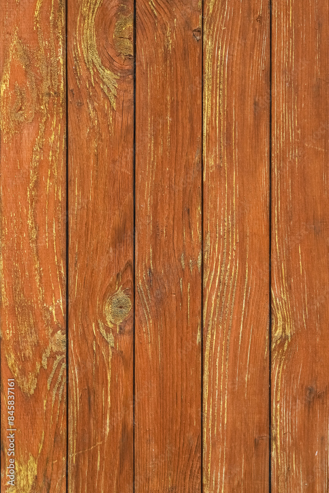 Naklejka premium Texture of an old cracked wall painted in orange made of wooden panels as a rustic natural background