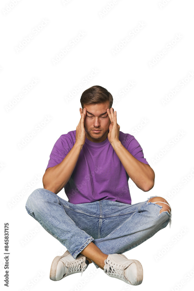 Casual man sitting on floor touching temples and having headache. Casual man sitting on floor touching temples and having headache.