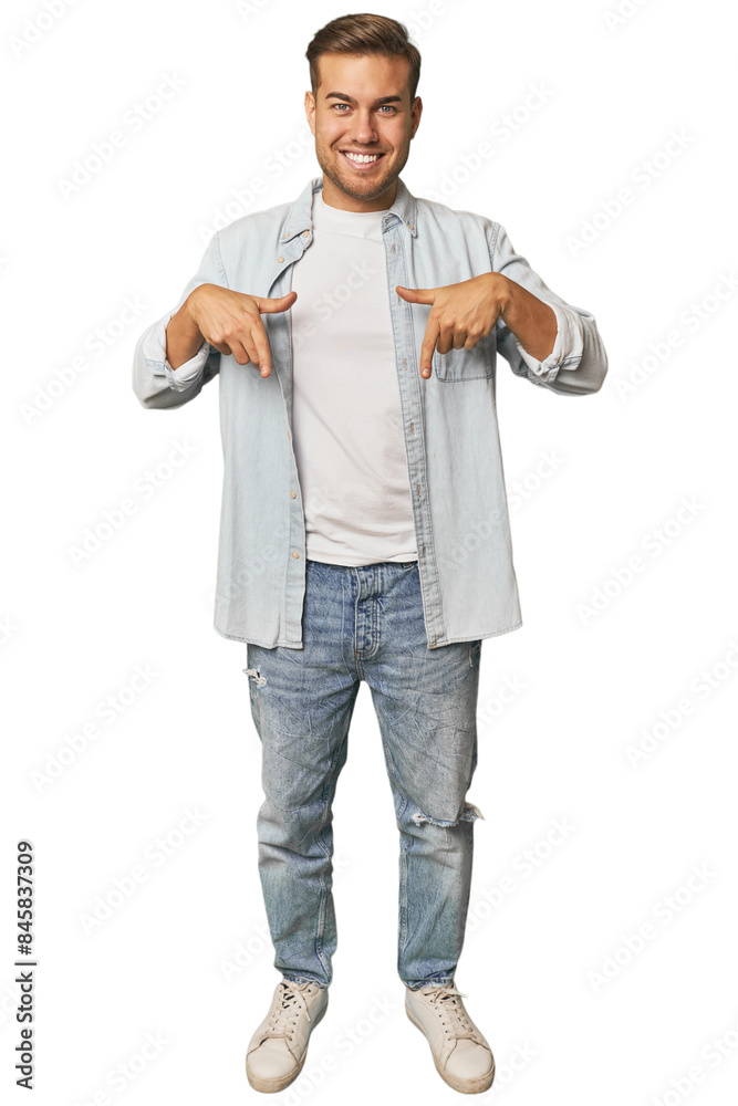 Full body portrait of a man in studio points down with fingers, positive feeling.