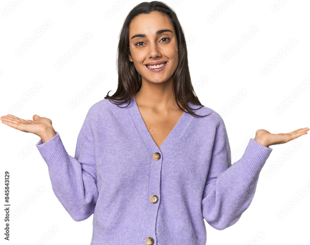 Hispanic young woman makes scale with arms, feels happy and confident. Hispanic young woman makes scale with arms, feels happy and confident.