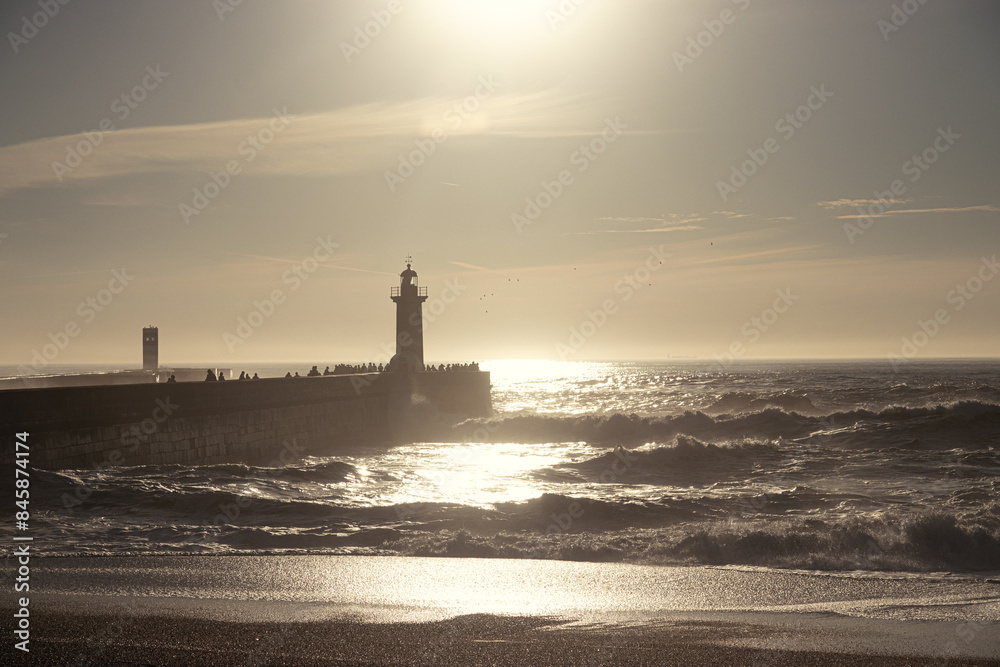 Fototapeta premium Sunset in the ocean by the lighthouse