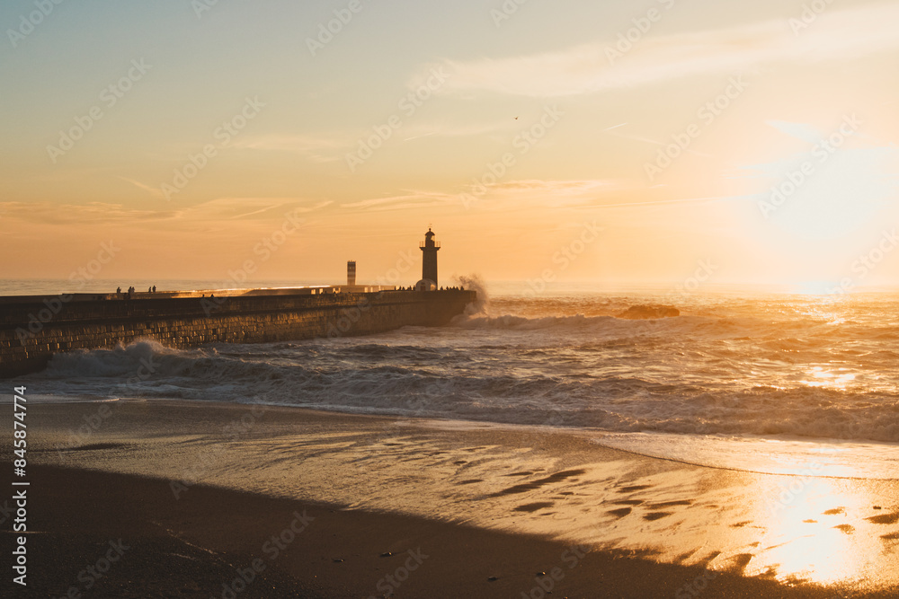 Fototapeta premium Sunset in the ocean by the lighthouse