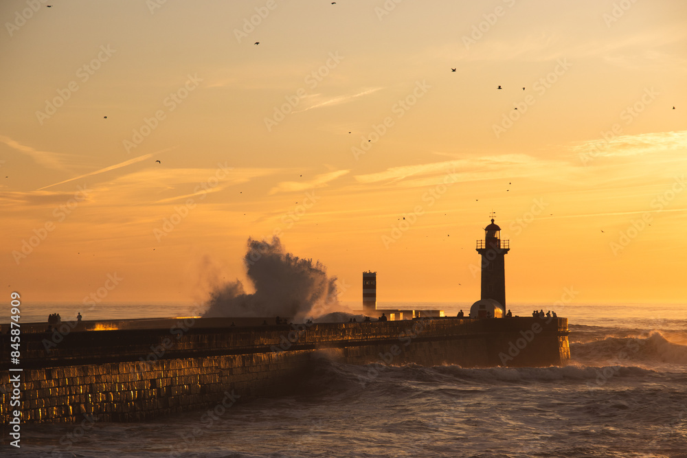Fototapeta premium Sunset in the ocean by the lighthouse