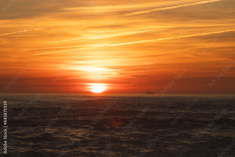 Fototapeta premium Sunset in the ocean by the lighthouse