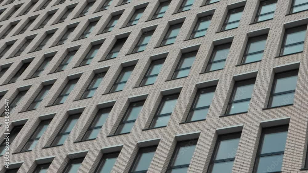 Panorama of Facade Multi-apartment new Building witn many windows. Slow motion. 