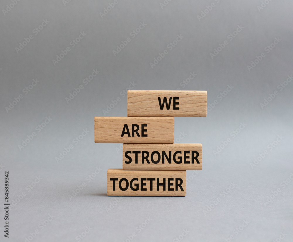 We are stronger together symbol. Wooden blocks with words We are stronger together. Beautiful grey background. We are stronger together concept. Copy space. We are stronger together symbol. Wooden blocks with words We are stronger together. Beautiful grey background. We are stronger together concept. Copy space.