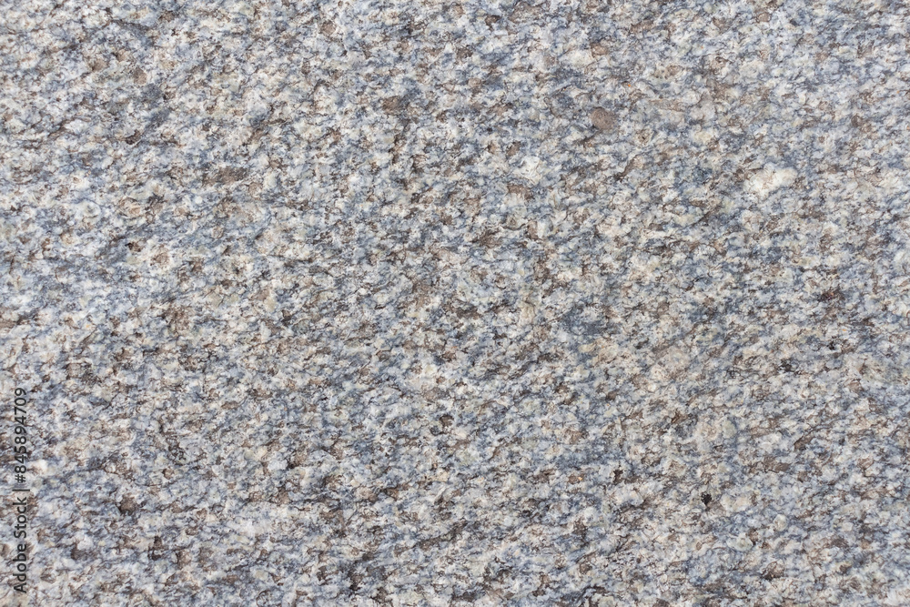 Abstract textured grey granite background. Close-up view of gray grainy stone surface. Soft focus. Copy space for your text or decoration. Real stone backdrop. Construction material theme. Abstract textured grey granite background. Close-up view of gray grainy stone surface. Soft focus. Copy space for your text or decoration. Real stone backdrop. Construction material theme.