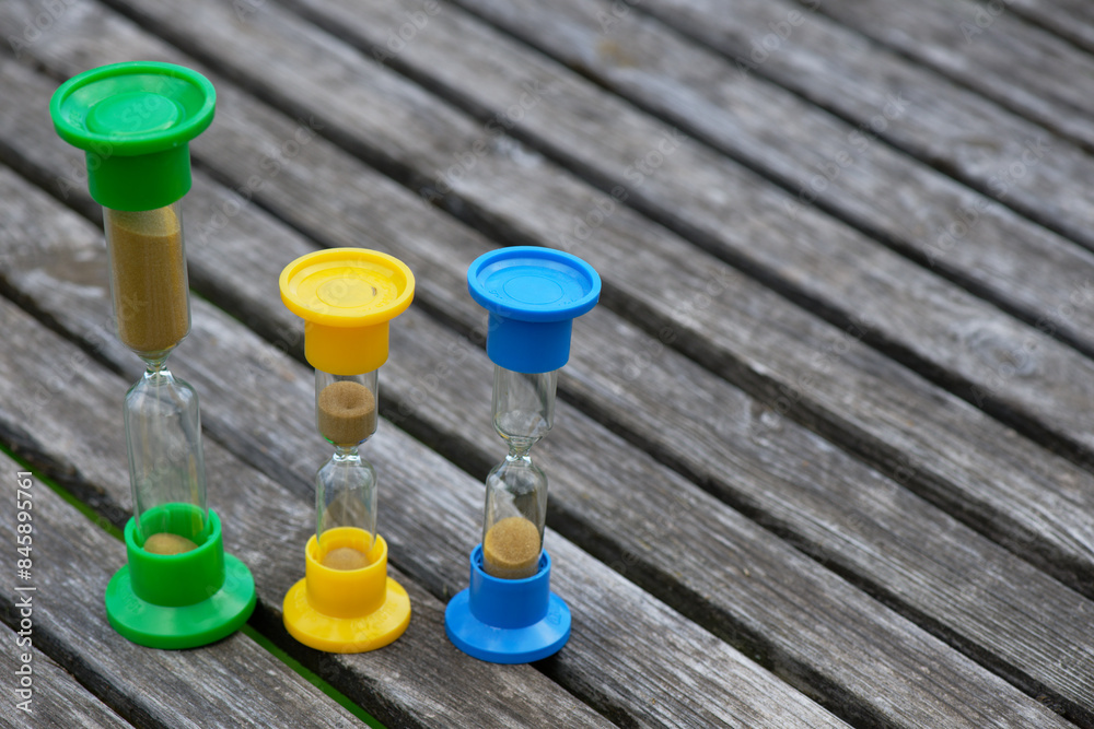 Hourglasses on rustic wooden table Hourglasses on rustic wooden table