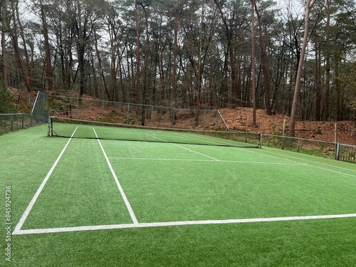 Tennis court with artificial grass and net outdoors