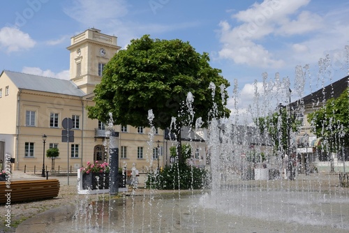 City fountain against the background of the town hall building on the market square in Kutno.