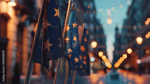 A row of flags waving in the wind on a city street at night, providing a colorful and vibrant atmosphere photo