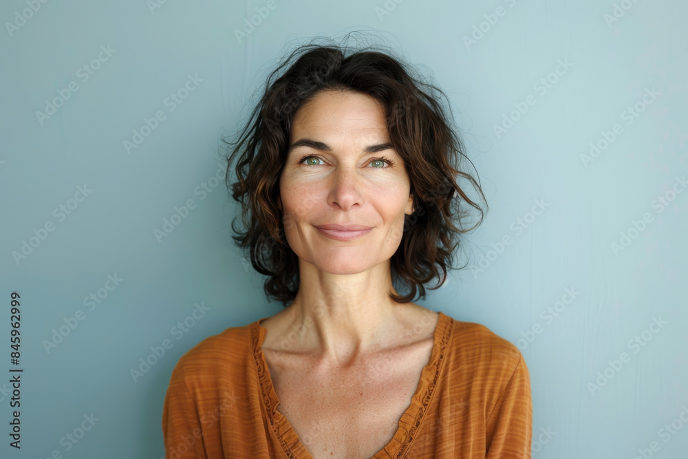 A close up portrait of a woman with a subtle smile A close up portrait of a woman with a subtle smile