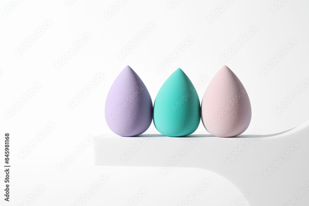 Stylish presentation of makeup sponges on white background, space for text Stylish presentation of makeup sponges on white background, space for text