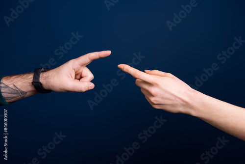 Photo of two people touch fingers reaching isolated dark color blue background