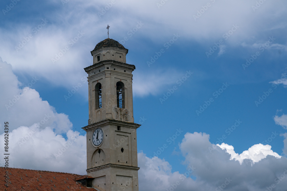 Christian church bell tower, sky and clouds background. clock and dome with cross and weathervane on a square base and dome on an octagonal base and stone roofing. Christian church bell tower, sky and clouds background. clock and dome with cross and weathervane on a square base and dome on an octagonal base and stone roofing.