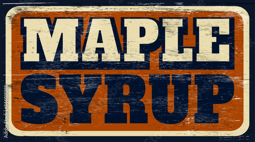 Aged and worn maple syrup sign on wood