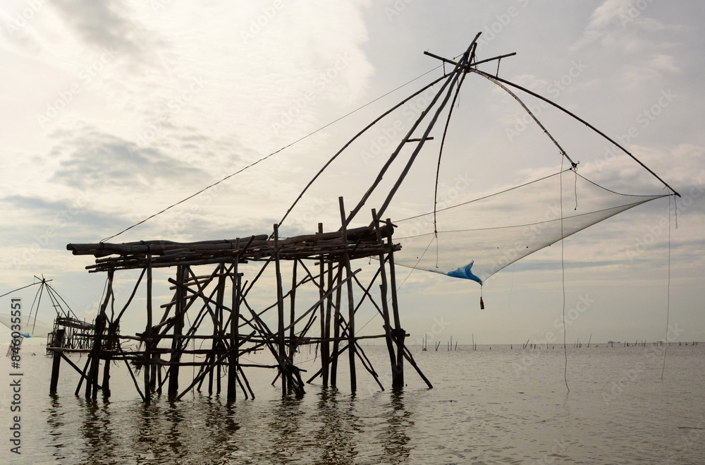 Fishing nets silhouettes at Thale Luang. Upper Songkhla lake. Phatthalung province. Thailand Fishing nets silhouettes at Thale Luang. Upper Songkhla lake. Phatthalung province. Thailand