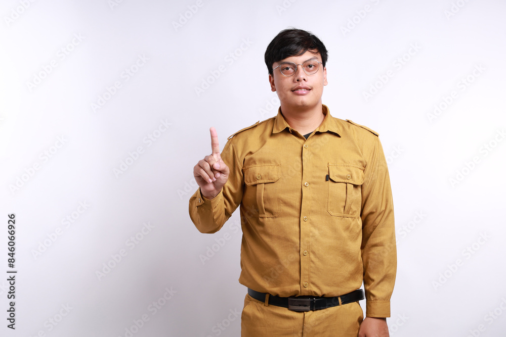 Enthusiastic Indonesian government employees standing while showing one finger. Isolated on white Enthusiastic Indonesian government employees standing while showing one finger. Isolated on white