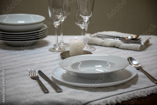 Luxurious table setting with white plates  crystal glasses and fine cutlery