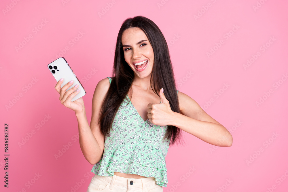 Photo of cheerful adorable woman blogger wear trendy clothes thumb up offer isolated on pink color background Photo of cheerful adorable woman blogger wear trendy clothes thumb up offer isolated on pink color background
