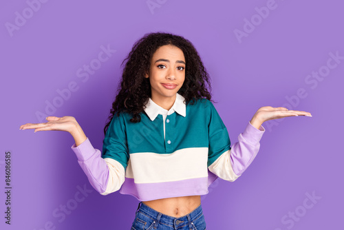 Photo of nice young girl shrug shoulders wear shirt isolated on violet color background