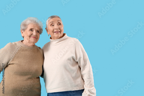 Senior female friends huggi...