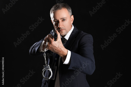 Mature FBI agent with gun a...
