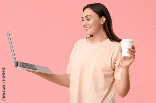 Smiling young woman holding...