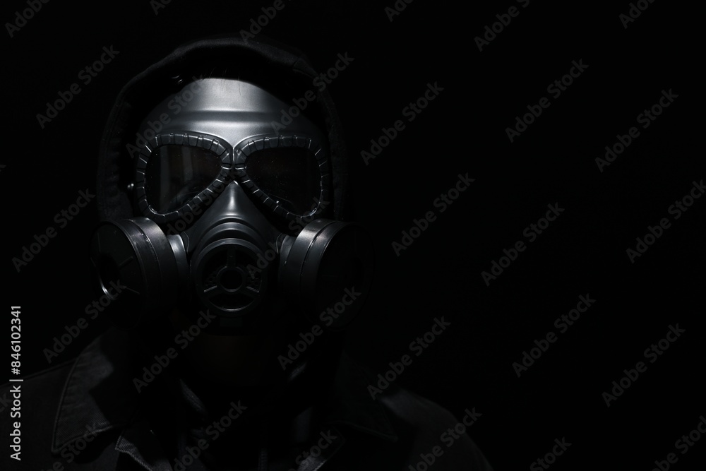 Man in gas mask on black background. Space for text Man in gas mask on black background. Space for text