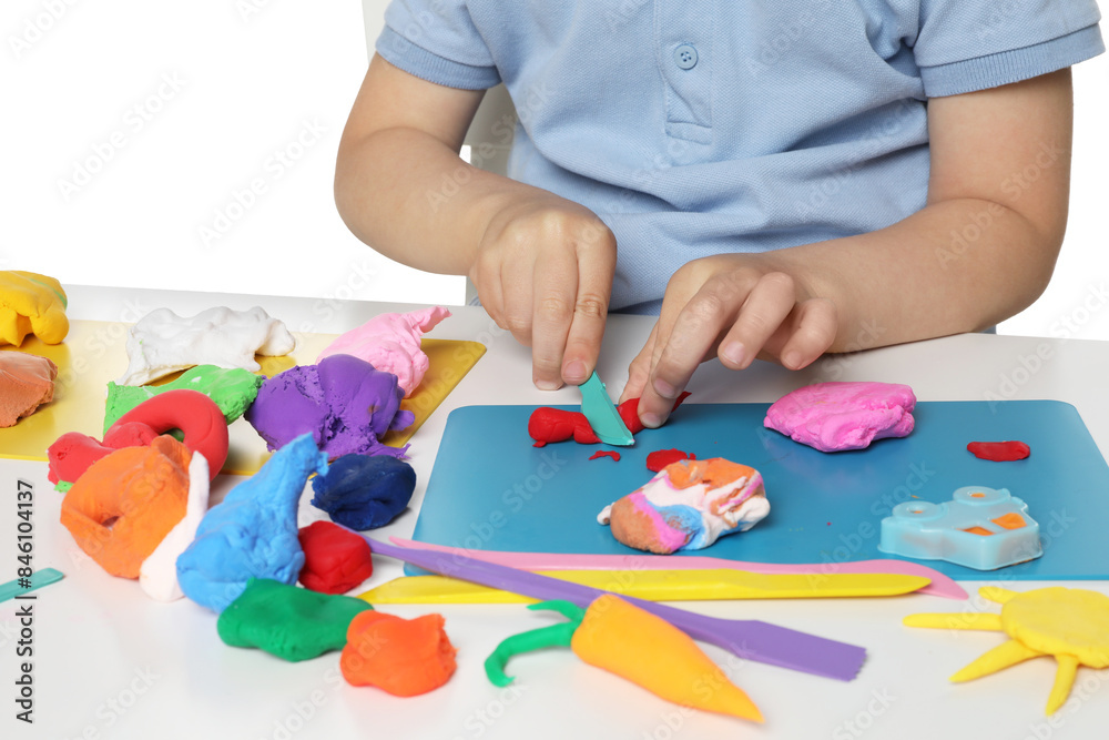 Little boy sculpting with play dough at table on white background, closeup Little boy sculpting with play dough at table on white background, closeup