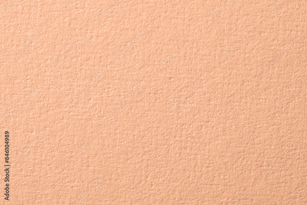 Peach fuzz color paper, closeup. Trendy shade of 2024 year