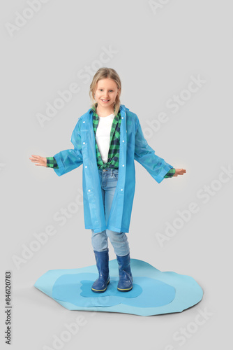 Adorable girl with raincoat...