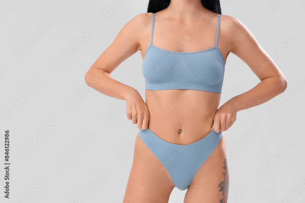 Beautiful young woman in light blue underwear on white background Beautiful young woman in light blue underwear on white background