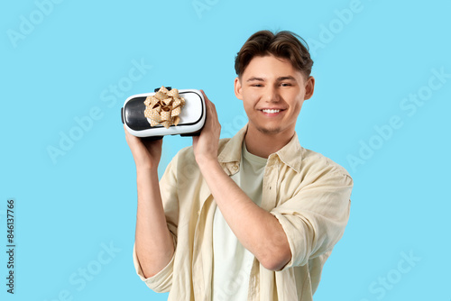 Young man with gift VR glas...