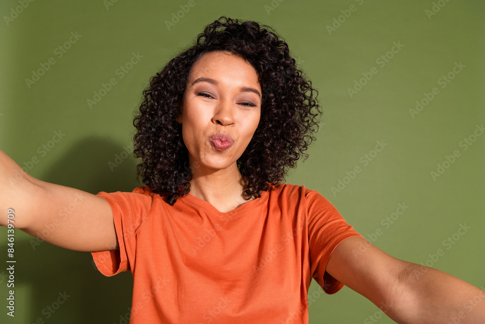 Photo portrait of attractive young woman selfie photo kissing dressed stylish orange clothes isolated on khaki color background Photo portrait of attractive young woman selfie photo kissing dressed stylish orange clothes isolated on khaki color background