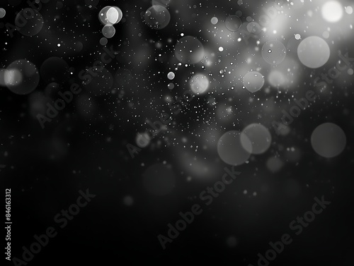 A black bokeh texture on black background with white dots