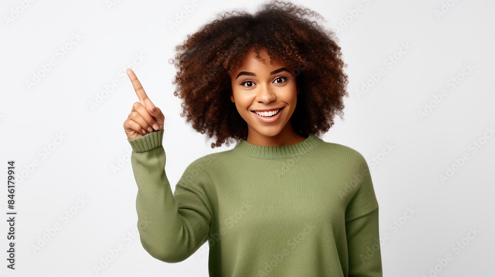 Fototapeta premium Beautiful young black woman pointing up to copy space