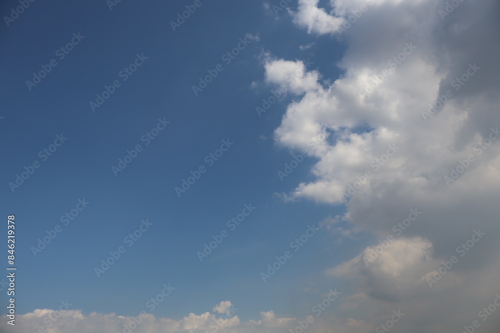 Fototapeta premium Natural Blue Sky with Randomly Shaped Clouds on One Side