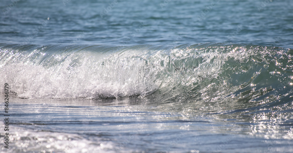 A sea wave breaks against the rocks, water splashes in the sky. Tidal wave. A sea wave breaks against the rocks, water splashes in the sky. Tidal wave.