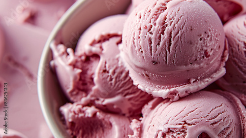 A close up of a pink ice cream cone, a delicious and refreshing summer treat often enjoyed as a sweet snack or dessert.