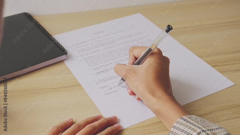 Hand Of Businesswomaan Sign The Contract Agreement In The Office, Top View Hand Of Businesswomaan Sign The Contract Agreement In The Office, Top View